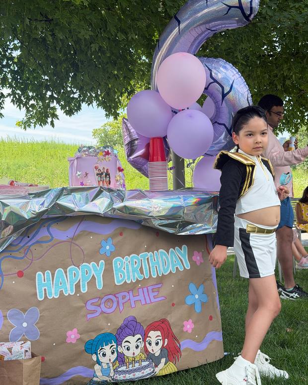 Hand-painted Happy Birthday Sophie banner at an outdoor party